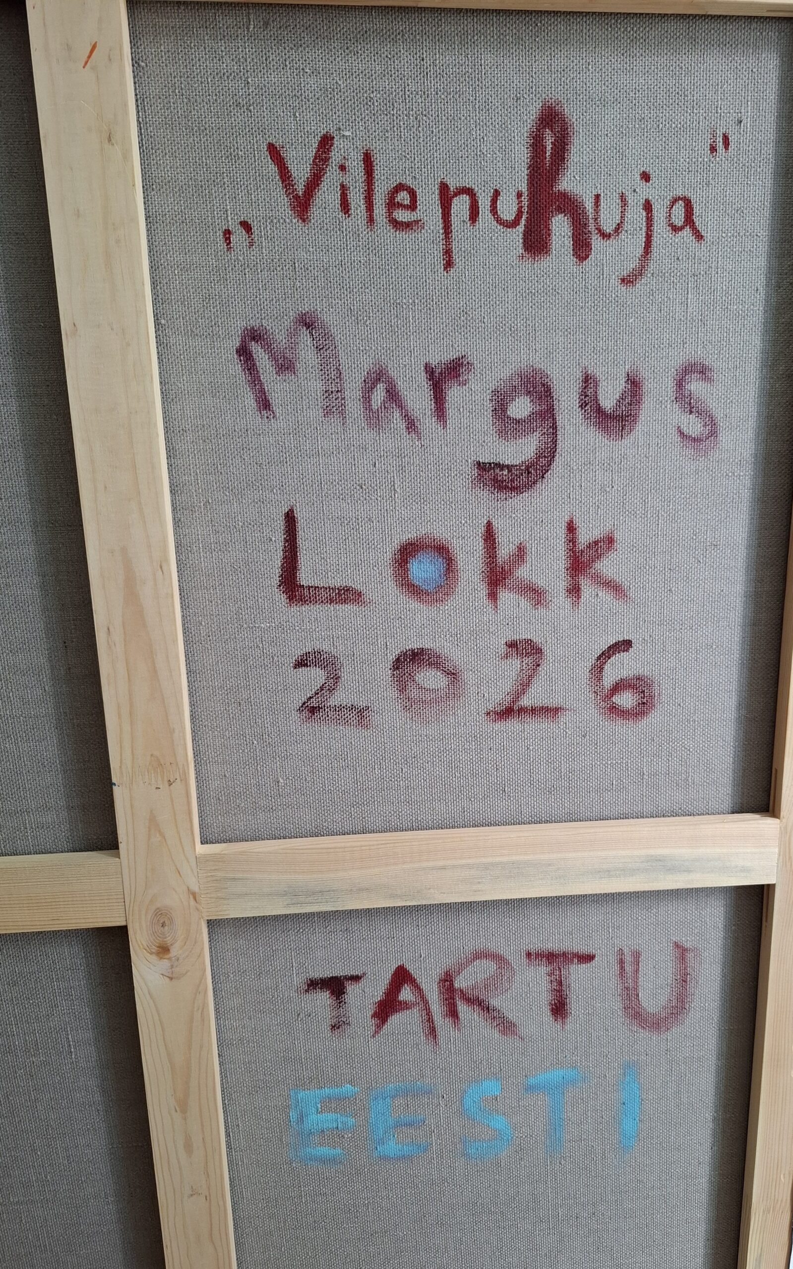 Back of a framed canvas with red handwritten text reading 'Vilenuhja Margus Look 2026' and blue letters 'EESTI' at the bottom.